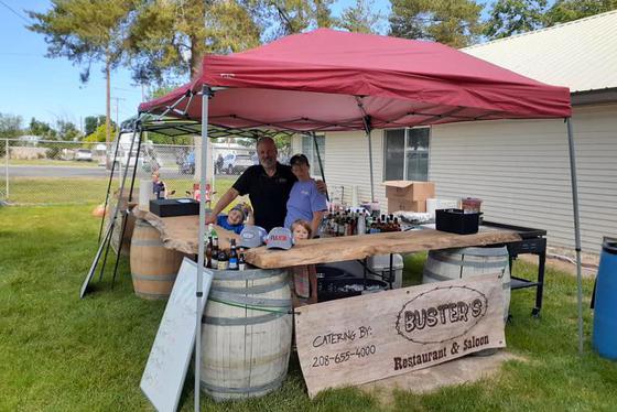 A picture of a Buster's catering stand in a large empty field.