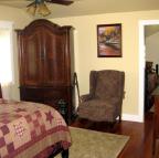 A picture of a beige-colored room with pink furniture.